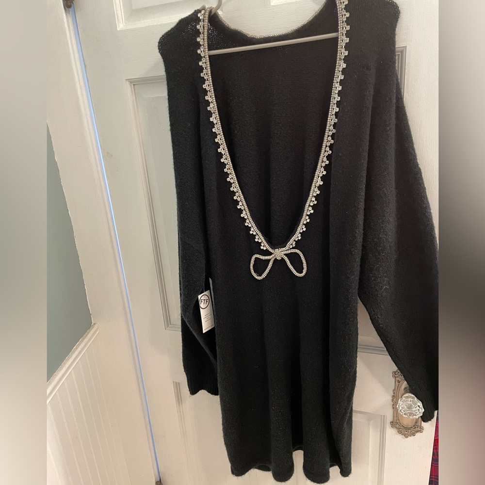 Black sweater dress with low drop back and diamond trim. Size 2x